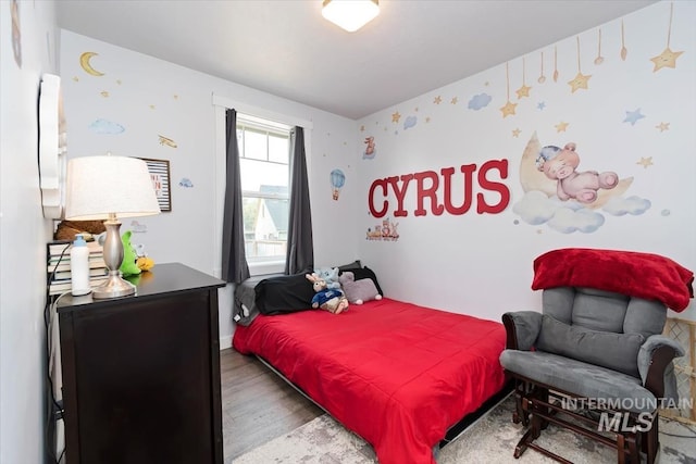 bedroom with hardwood / wood-style floors