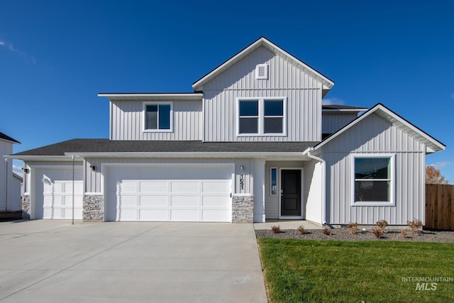 modern farmhouse style home featuring board and batten siding, concrete driveway, and fence