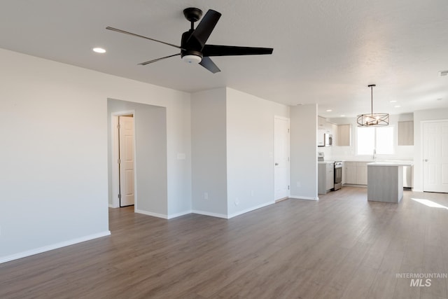 unfurnished living room with visible vents, wood finished floors, recessed lighting, baseboards, and ceiling fan