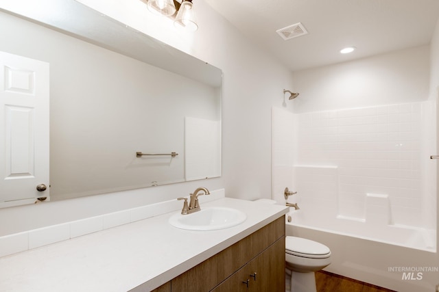 full bath with visible vents, toilet, recessed lighting, washtub / shower combination, and vanity