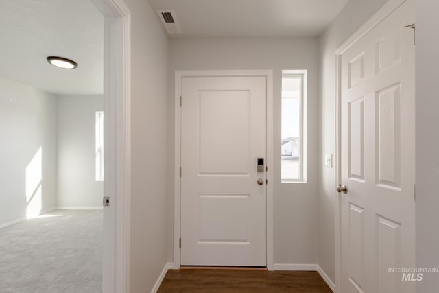 foyer entrance featuring a wealth of natural light, visible vents, and baseboards