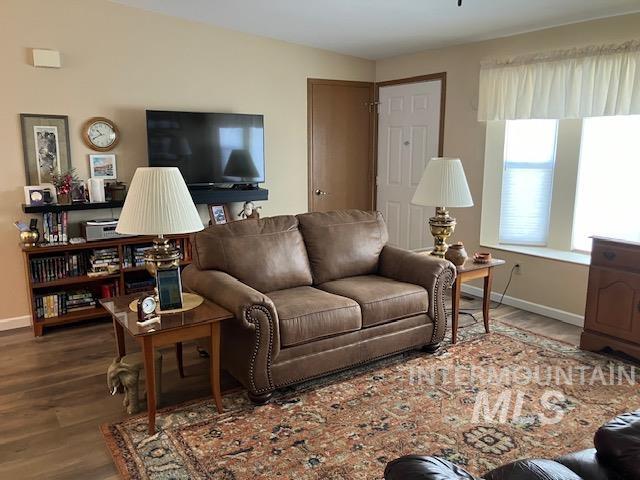 living room with baseboards and wood finished floors