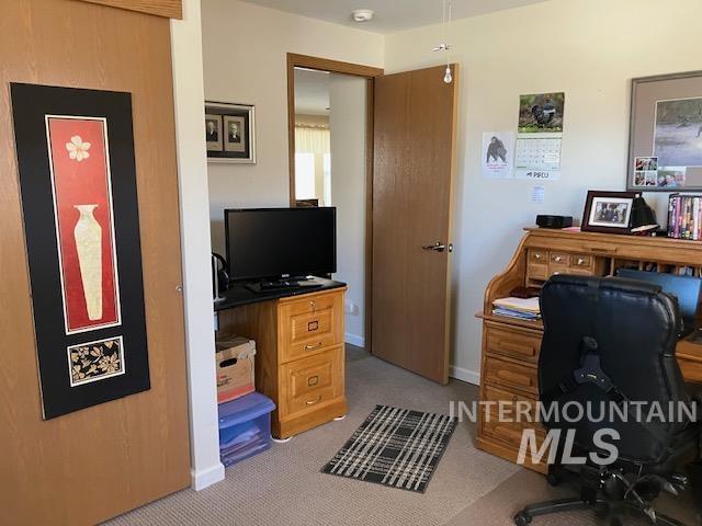 home office with baseboards and carpet