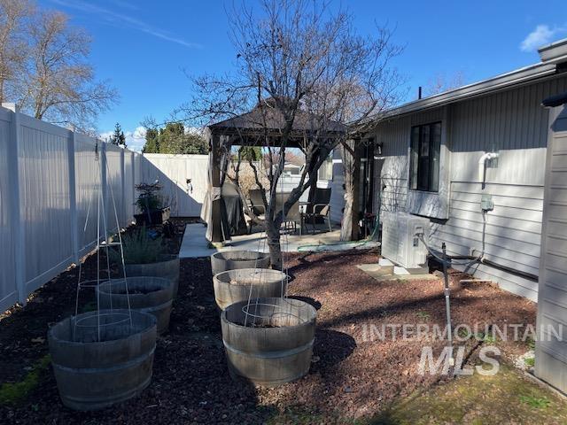 view of yard with a gazebo, a patio area, and a fenced backyard