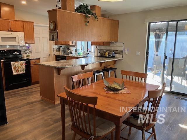 dining area featuring a healthy amount of sunlight and wood finished floors