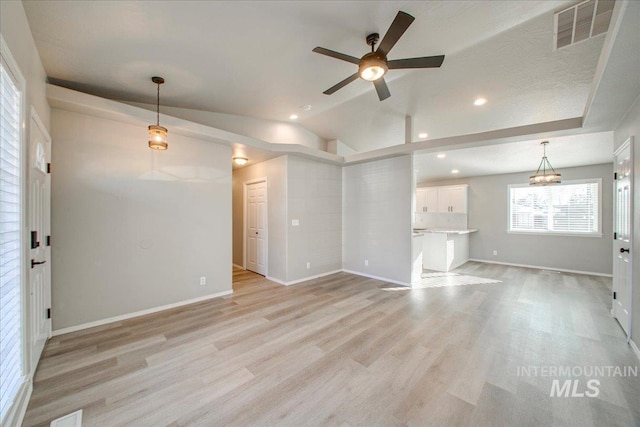 10683 W Capella St, Star, ID 83669 - unfurnished living room with light wood-type flooring, vaulted ceiling, and ceiling fan