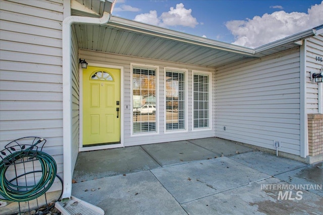 view of exterior entry featuring a patio area