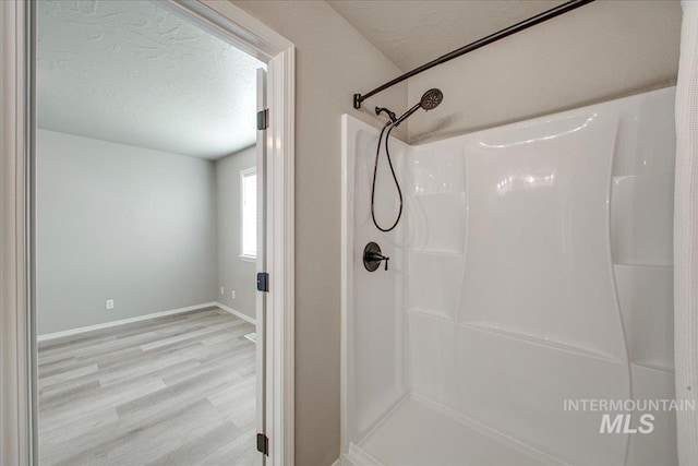 10683 W Capella St, Star, ID 83669 - bathroom featuring wood-type flooring, a textured ceiling, and a shower