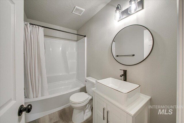 10683 W Capella St, Star, ID 83669 - full bathroom with vanity, hardwood / wood-style flooring, shower / tub combo with curtain, and toilet