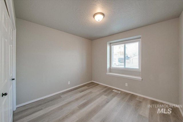 10683 W Capella St, Star, ID 83669 - empty room featuring light hardwood / wood-style floors and a textured ceiling