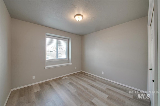 10683 W Capella St, Star, ID 83669 - empty room with a textured ceiling and light hardwood / wood-style flooring