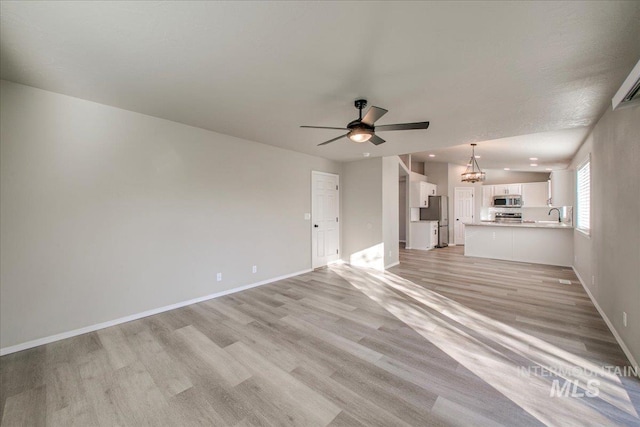 10683 W Capella St, Star, ID 83669 - unfurnished living room featuring sink, ceiling fan, and light hardwood / wood-style floors