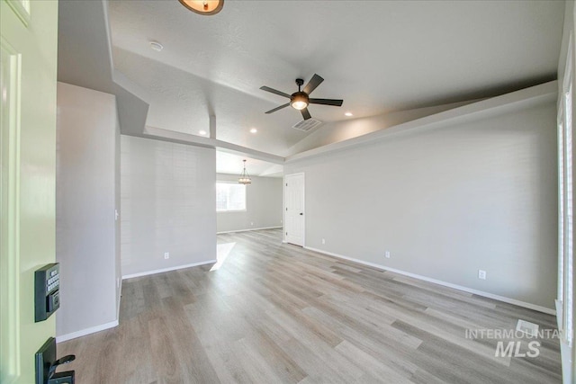 10683 W Capella St, Star, ID 83669 - unfurnished room with ceiling fan with notable chandelier, light hardwood / wood-style flooring, and lofted ceiling