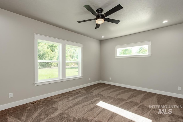 unfurnished room with carpet and ceiling fan