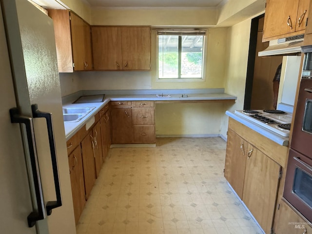 187 Harmony Heights Loop, Orofino, ID 83544 - kitchen featuring refrigerator, light flooring, under cabinet range hood, white electric cooktop, and light countertops