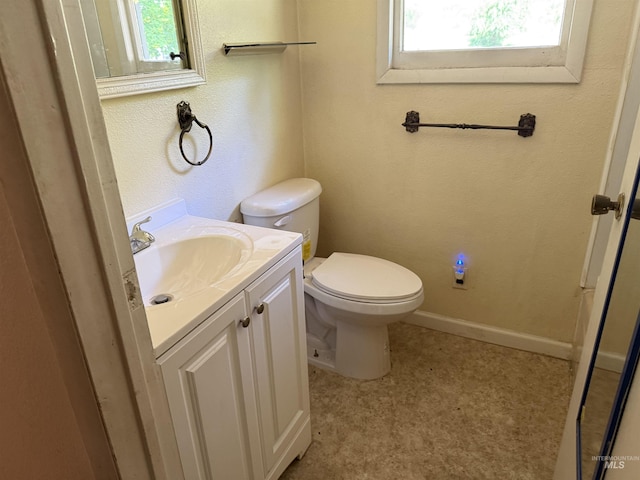 187 Harmony Heights Loop, Orofino, ID 83544 - half bathroom featuring vanity, tile patterned floors, toilet, baseboards, and a textured wall