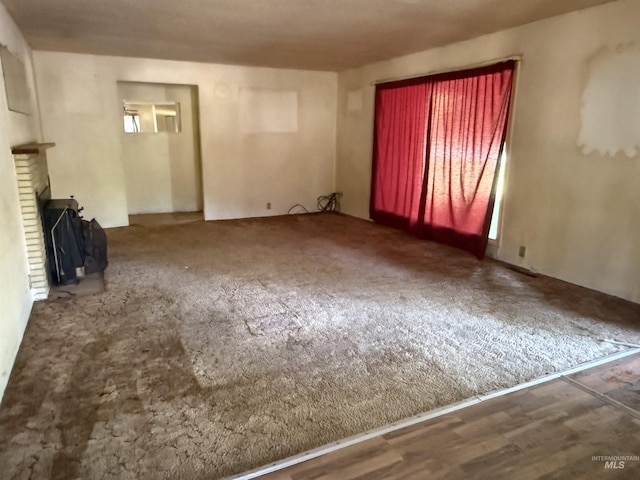 187 Harmony Heights Loop, Orofino, ID 83544 - unfurnished living room with a fireplace and carpet