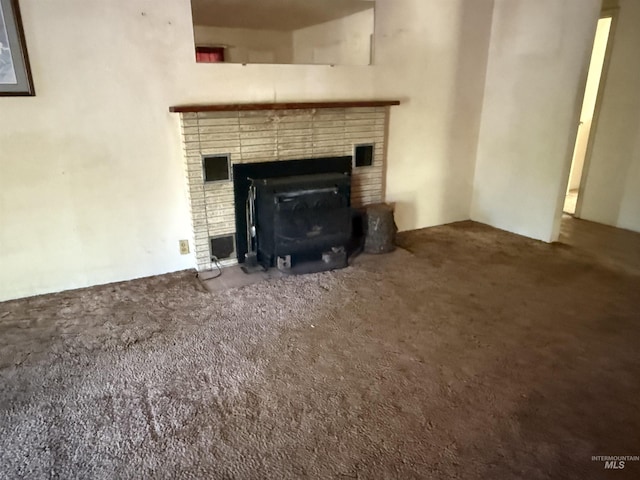 187 Harmony Heights Loop, Orofino, ID 83544 - unfurnished living room with a brick fireplace and carpet