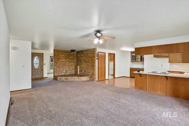 16476 Ustick Rd, Caldwell, ID 83607 - unfurnished living room featuring a ceiling fan, carpet floors, and baseboards