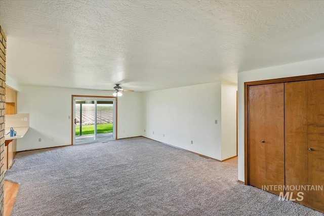 16476 Ustick Rd, Caldwell, ID 83607 - unfurnished living room with light colored carpet, a ceiling fan, baseboards, and a textured ceiling