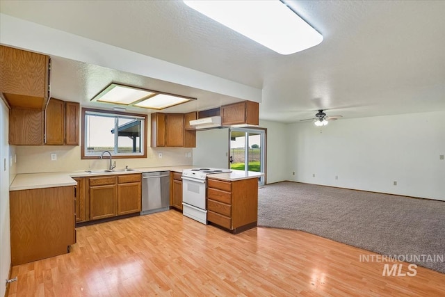 16476 Ustick Rd, Caldwell, ID 83607 - kitchen with white range with electric cooktop, stainless steel dishwasher, a sink, and brown cabinets