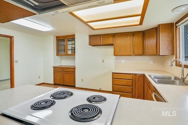 16476 Ustick Rd, Caldwell, ID 83607 - kitchen with stove, brown cabinetry, a sink, light countertops, and glass insert cabinets