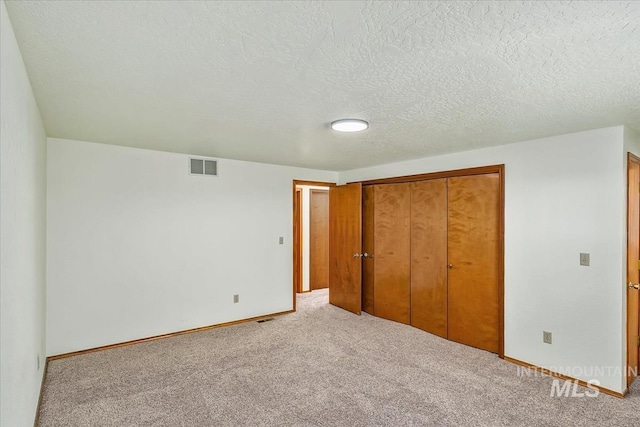 16476 Ustick Rd, Caldwell, ID 83607 - unfurnished bedroom featuring a closet, carpet flooring, baseboards, and a textured ceiling