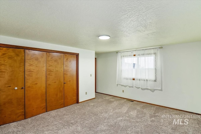 16476 Ustick Rd, Caldwell, ID 83607 - unfurnished bedroom featuring carpet floors, a textured ceiling, a closet, and baseboards
