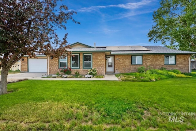 16476 Ustick Rd, Caldwell, ID 83607 - single story home featuring concrete driveway, a front yard, solar panels, an attached garage, and brick siding