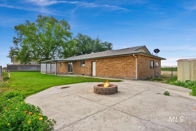 16476 Ustick Rd, Caldwell, ID 83607 - rear view of house featuring a patio, brick siding, and an outdoor fire pit