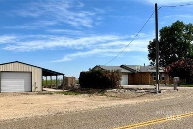 16476 Ustick Rd, Caldwell, ID 83607 - view of front of property featuring a garage and dirt driveway