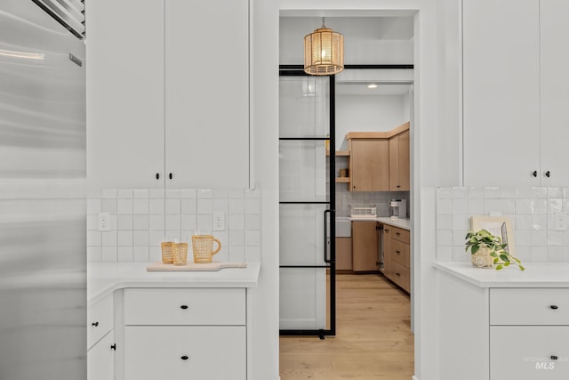 kitchen with fridge, built in refrigerator, and light countertops