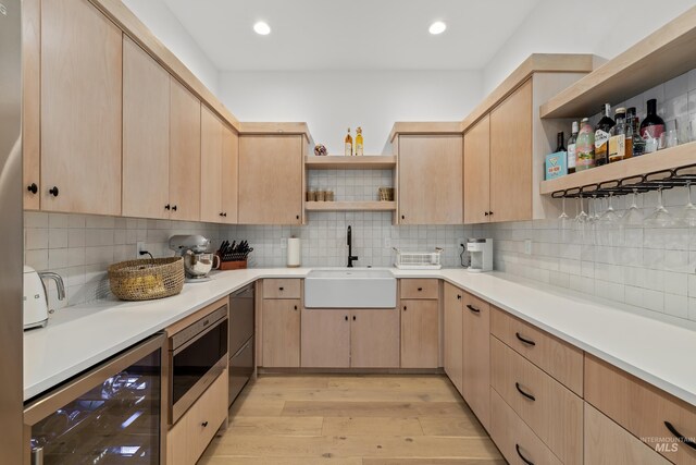 kitchen featuring open shelves, light brown cabinets, and a sink