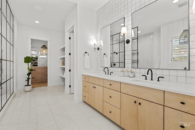 full bathroom with a sink, visible vents, and decorative backsplash