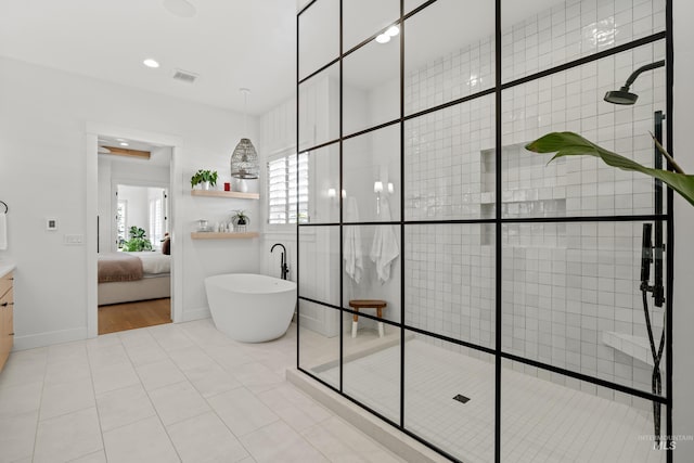 full bathroom with ensuite bath, a soaking tub, visible vents, and a shower stall