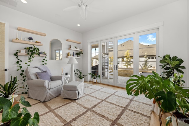 sitting room with arched walkways, visible vents, recessed lighting, and a ceiling fan