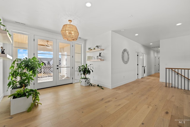 entryway featuring a notable chandelier, recessed lighting, light wood-type flooring, and baseboards