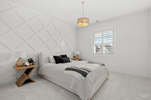 bedroom with baseboards, visible vents, and carpet floors