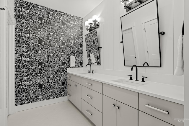 full bathroom featuring double vanity and a sink