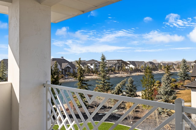 balcony featuring a residential view and a water view