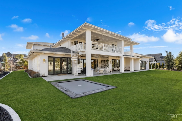 back of property with ceiling fan, stairs, a yard, a balcony, and a patio area