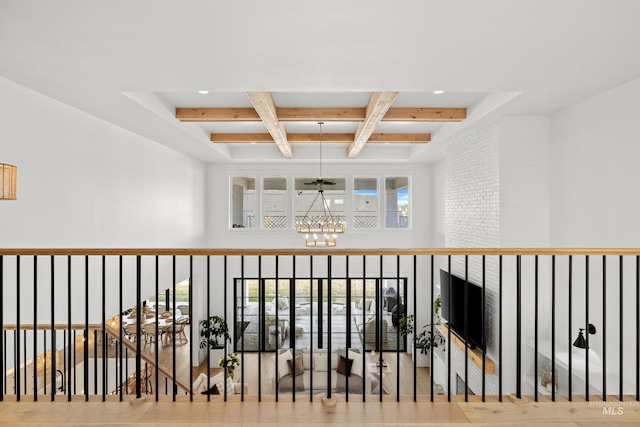 corridor with a chandelier, beam ceiling, coffered ceiling, and a towering ceiling