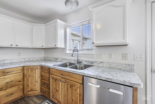 kitchen with light countertops, dishwasher, a sink, and white cabinetry
