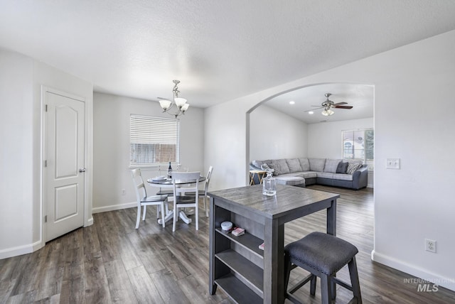 interior space with plenty of natural light, arched walkways, and dark wood-style flooring