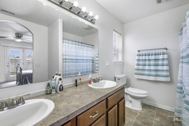 full bathroom with a sink, visible vents, ceiling fan, and double vanity