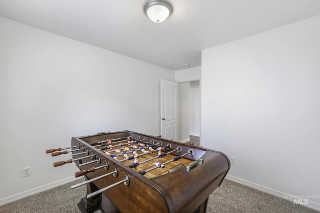 rec room with baseboards and carpet flooring