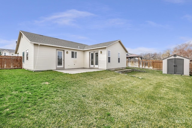 back of property with a storage shed, a yard, a patio area, a fenced backyard, and an outdoor structure