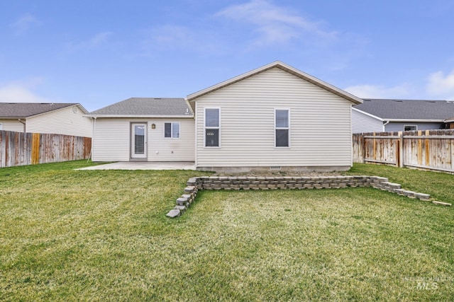 rear view of property with a patio, a yard, and a fenced backyard