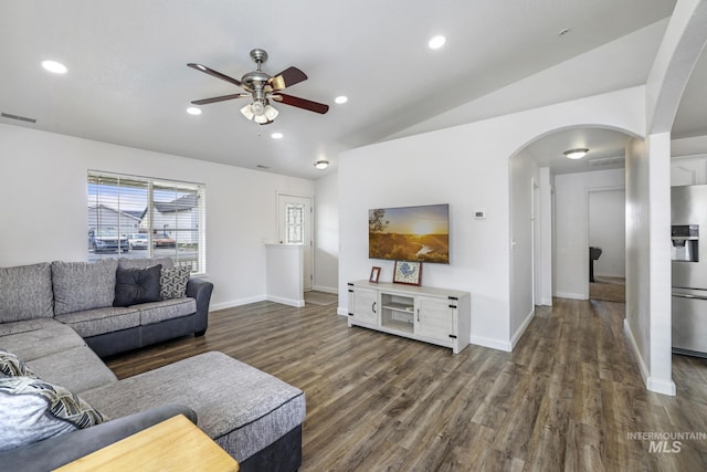 living area featuring ceiling fan, dark wood finished floors, arched walkways, vaulted ceiling, and visible vents