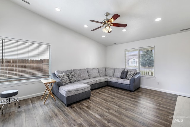 living area with ceiling fan, baseboards, visible vents, and wood finished floors